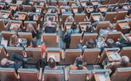 Seated adults in a lecture hall