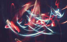 White and red light trails forming abstract patterns in a dark setting White and red light trails forming abstract patterns in a dark setting