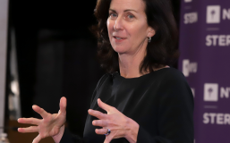 kathleen derose in a black blouse speaking to an audience