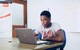 Student watches video on laptop