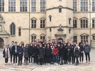 A group of students stands in front of Kronborg Castle