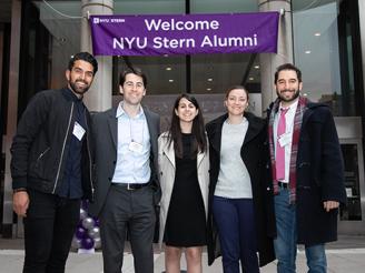 NYU Stern Reunion 2019 Alumni in front of Welcome NYU Stern Alumni sign in Gould Plaza