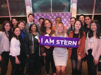 Dean Menon and students posing with an "I Am Stern" banner