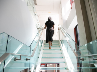 Woman walking up set of stairs
