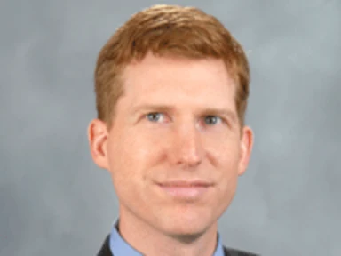 headshot of robert seamans in front of a grey background