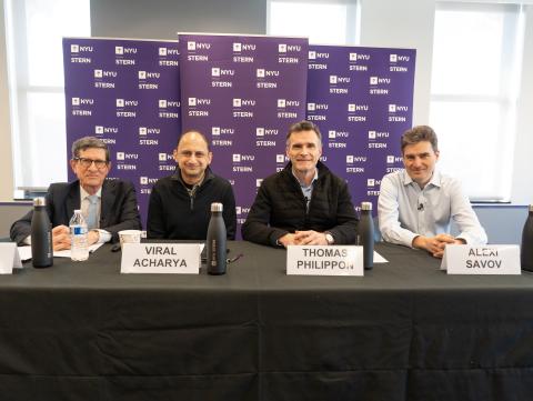 professors richard berner, viral acharya, thomas philippon, and alexi savov sitting at a table together, smiling while facing the camera