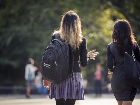 Two students walking through Washington Square Park