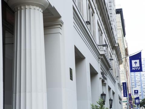 Column of a building and NYU flag