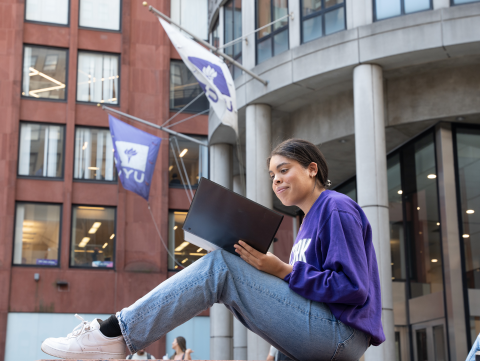 A student poses on Gould Plaza