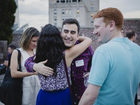 Alumni gather at an Outclass rooftop soiree