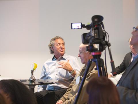 Harry Chernoff speaking and being recorded by a camera