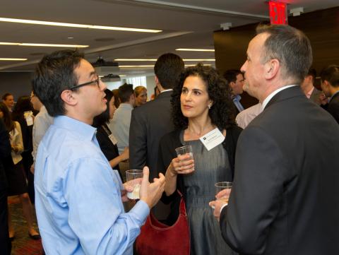 Three people with drinks, talking