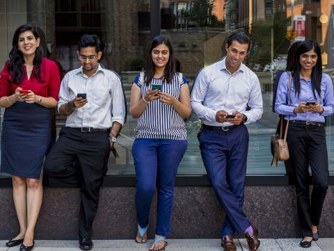 Students on their phones in Gould Plaza