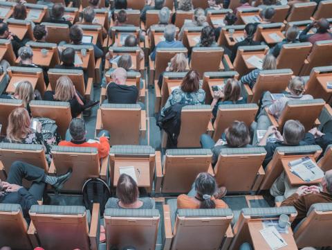 Seated adults in a lecture hall