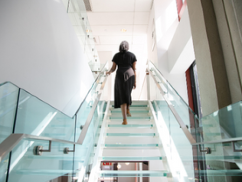 Woman walking up set of stairs