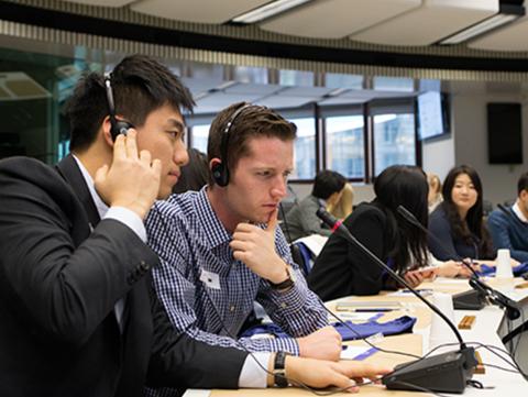 Matt Robinson and other students in the European Union with headsets on