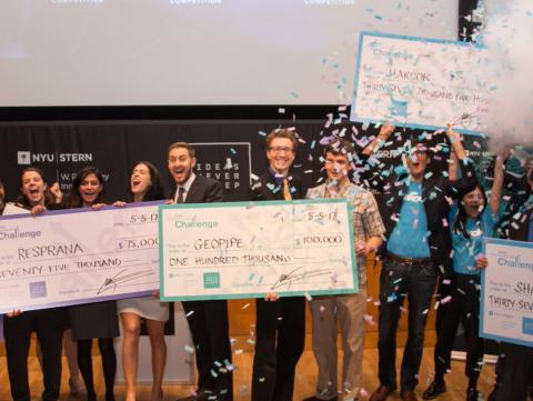 NYU Stern teams hold their checks and celebrate at the 300k Challenge Awards