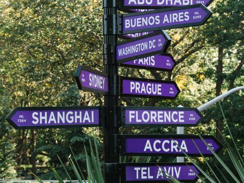 A sign on NYU's campus pointing to its other global sites