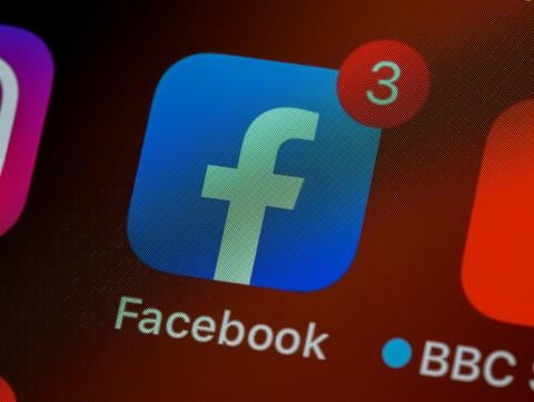 Facebook icon on phone screen