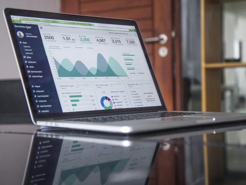 A laptop screen showing graphs and numbers