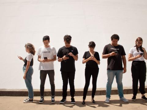 group of people staring at smartphones
