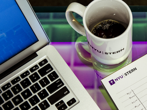 Laptop, NYU Stern mug, and notepad 