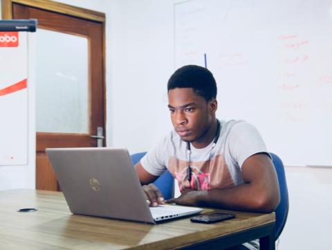 Student watches video on laptop