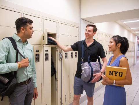 Students talking by lockers Students talking by a locker