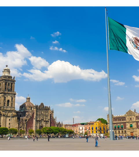 Mexico City's Zocalo with a Mexican flag in front of Mexico City Metropolitan Cathedral