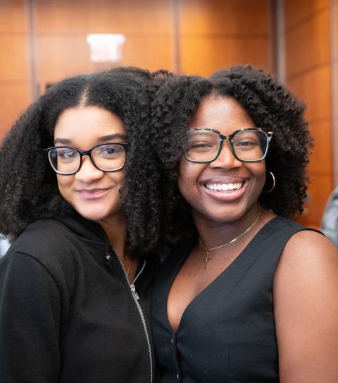 two individuals smiling