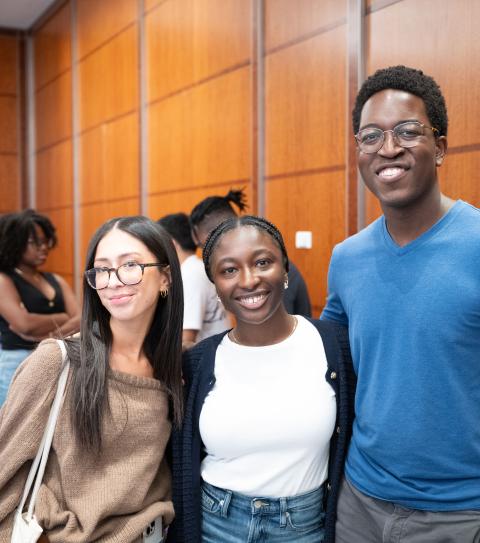 three students smiling next to each other