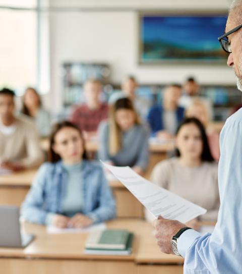 Out of focus students looking to their instructor