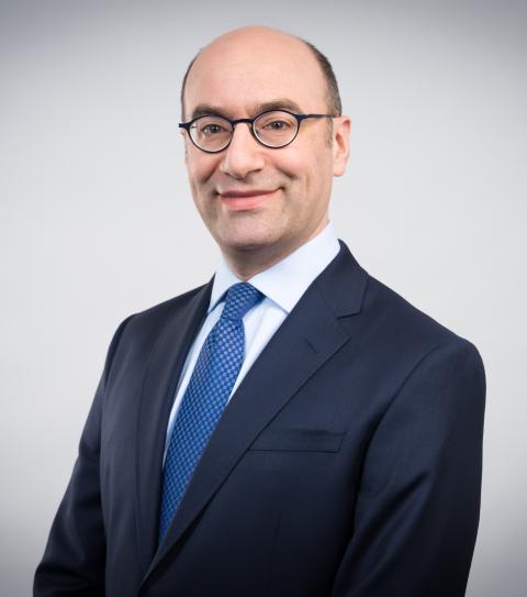 Steven A. Altman in business attire with a white background