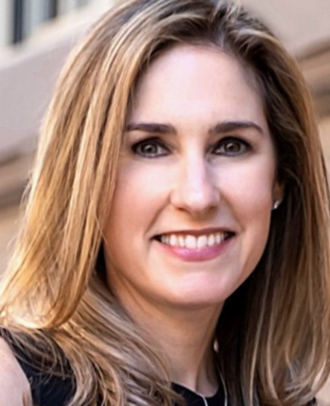 A portrait of Allison Samtur - a blonde, white woman smiling at the camera