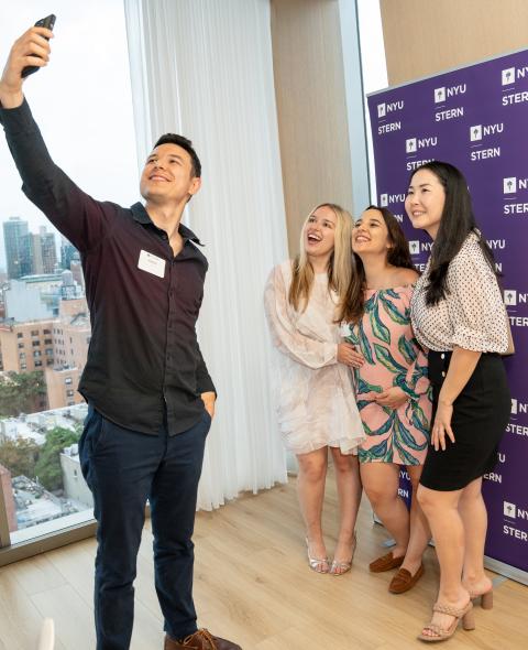 Stern alumni pose for a selfie