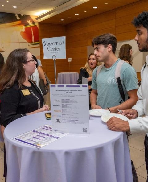 Wasserman administrator talking with students at table