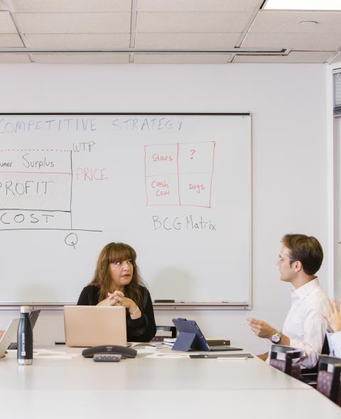 Professor in classroom with four students