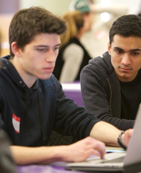 Students gathered by a computer