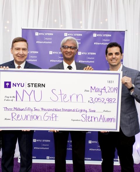 Sternies present Dean Raghu Sundaram with a check at Reunion