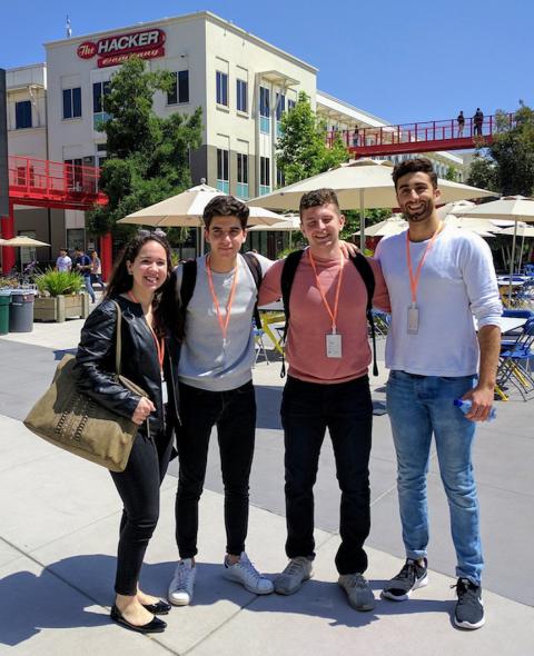 Four students standing next to each other at an outside plaza in San Francisco