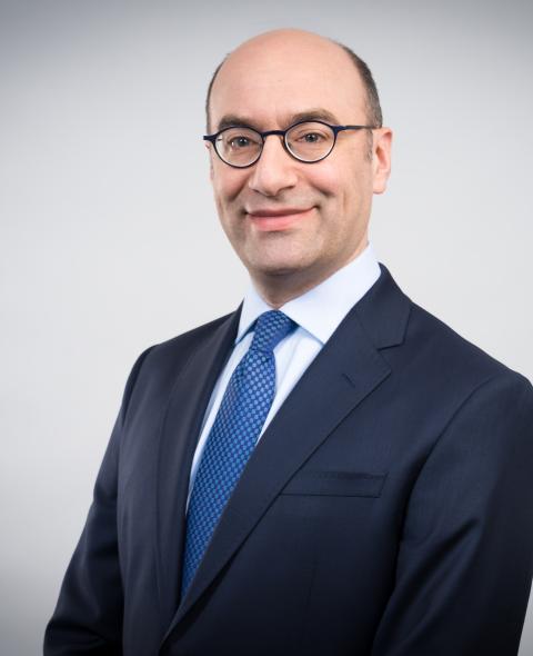 Steven A. Altman in business attire with a white background