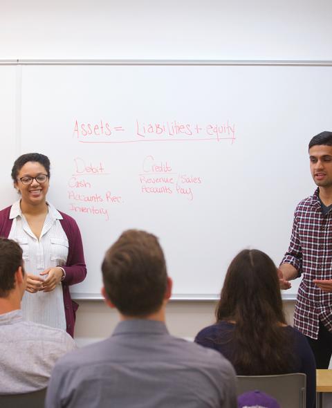 Students give a presentation in a classroom