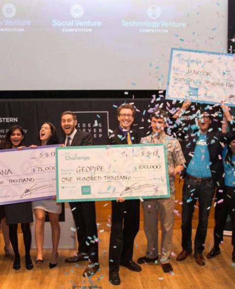 NYU Stern teams hold their checks and celebrate at the 300k Challenge Awards