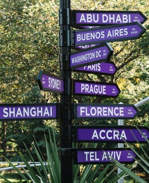 A sign on NYU's campus pointing to its other global sites