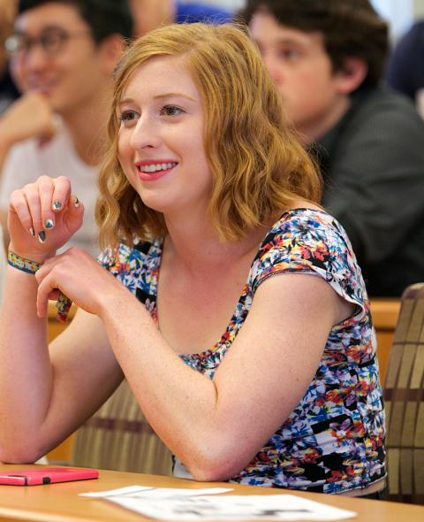 A student listens in a classroom in NYU Stern