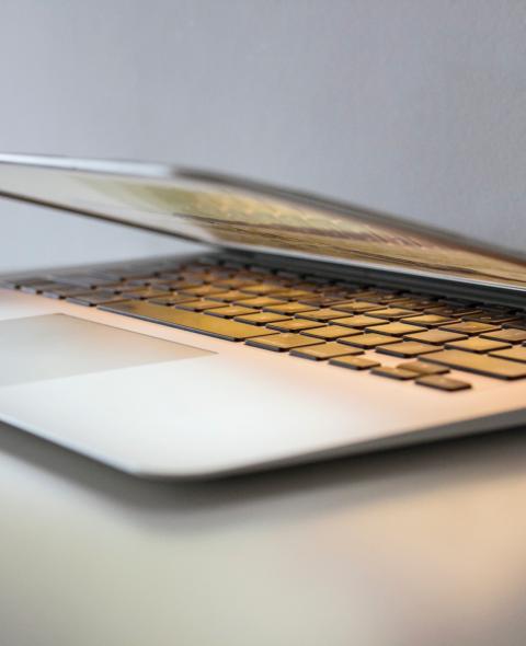 A half open laptop on a table