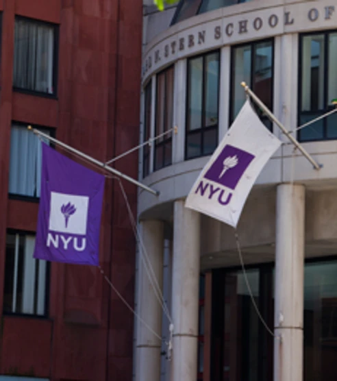 NYU flags outside of the Henry Kaufman Management Center