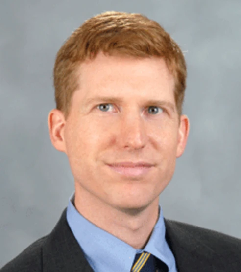 headshot of robert seamans in front of a grey background