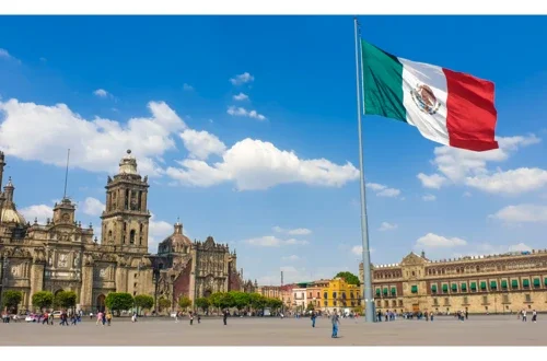 Mexico City's Zocalo with a Mexican flag in front of Mexico City Metropolitan Cathedral