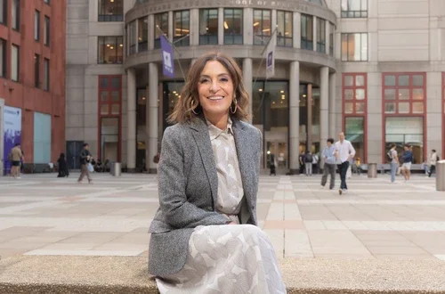 Suzy Welch sitting in front of NYU Stern